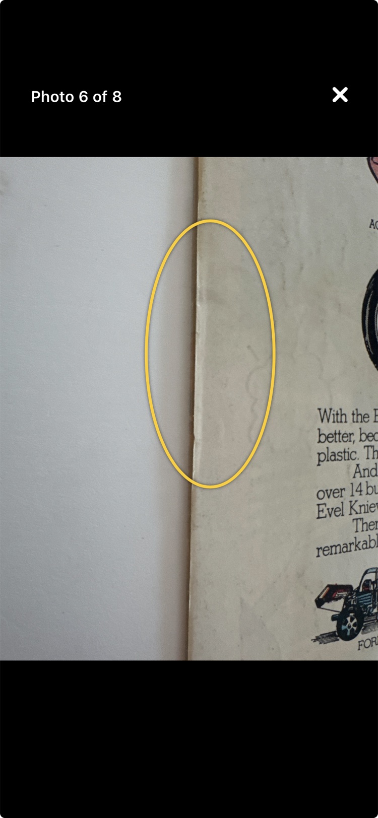 An annotated photo: a yellow ellipse drawn along the cover's edge showing the bend left where fingers grip the book.