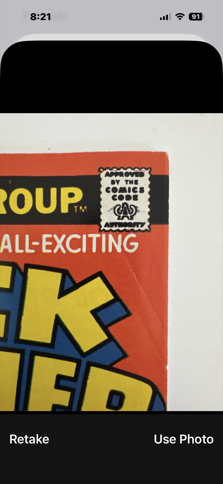 A close-up of the upper-right corner of the front cover, where a crease runs through the logo.